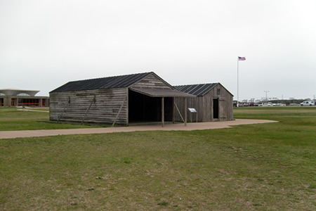 Replicas of the hangar (left) and living quarters (right)
The quarters had a wood stove in it for heat and cooking, table, chairs, bunks hanging from the rafters.

