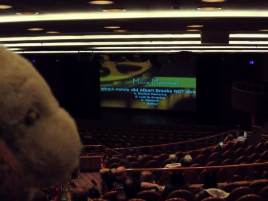 George playing trivia game in the theater
