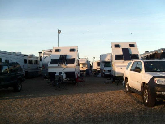 Twin A frame popup trailers with vertical solar panels down center
