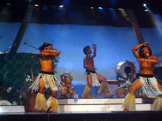 Guy on the right is sticking out his tongue to scare enemies by appearing more menacing.
