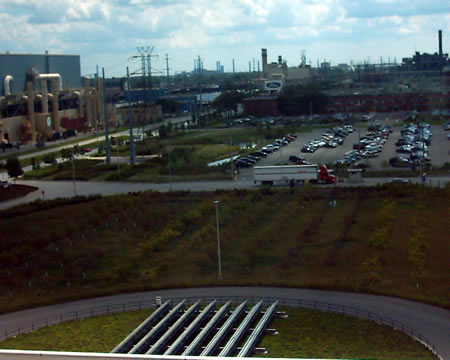 Solar panels in the foreground to provide some extra electricity, an apple orchard in the middle, and a parking lot built with the porous pavement they are testing to let the rain go through.
