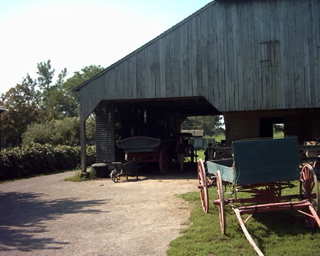 Wagons stored below the barn on the left side.
