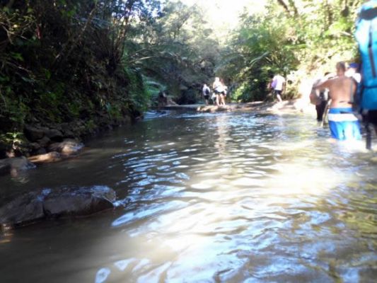 Wading the river to get to a waterfall
