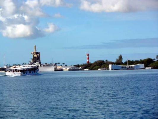 USS Missouri and the USS Arizona Memorial with shuttle on the way
