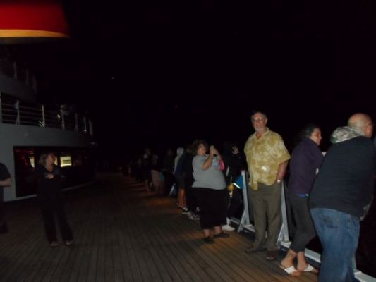 Up at midnight as we pass a lava flow
Captain routed us around the island tip to catch sight of the lava far off very late at night. Bunches of people including children woke up for it.
