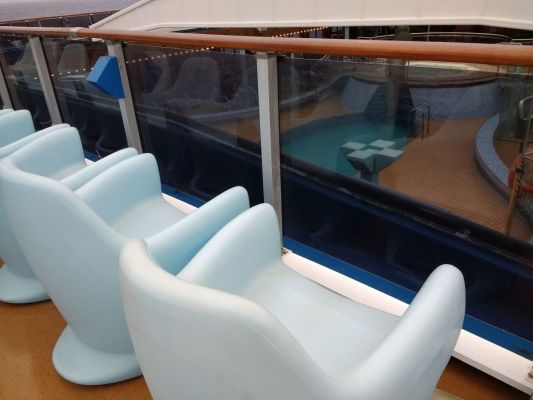 Nice plastic rocking chairs overlooking the pool
