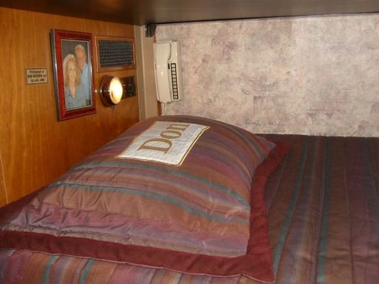 Bunkbed in Dolly's motorhome. Each has a phone.
