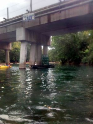 Litter boat under the bridge
