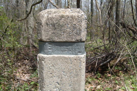 Cement posts with metal bands also point the way at crossroads
