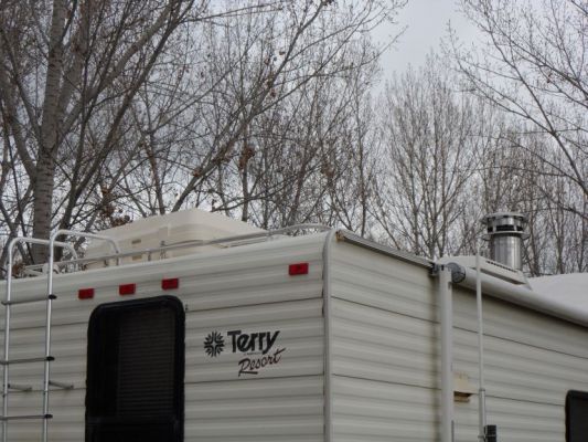 Storage pod on top and woodstove chimney
