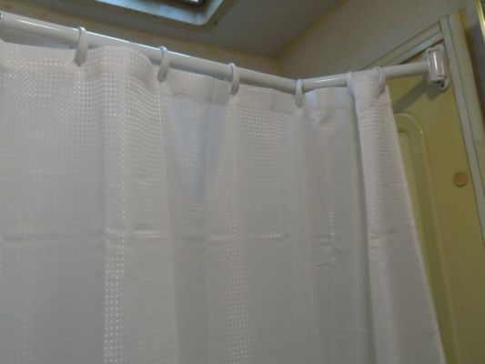 Extend-A-Shower
Great investment! Folds out to provide more room and keep curtain off me then in to act as a laundry or coat hanger/dryer.
