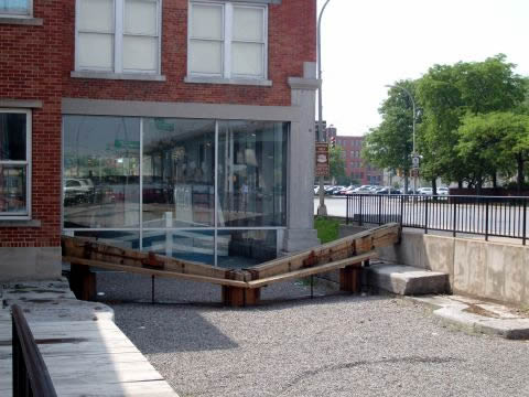 Old canal and locks at the museum
The Erie Canal Museum was once a weigh station directly on the Erie Canal which ran through here but has since been rerouted away. The glass enclosure was open with a lock on either end of the building. The water was lowered and the boat would come to rest on a scale to weigh it. The weight at the beginning of the season was deducted from current weight and a toll was paid on the result. Tolls were abolished after the canal building cost was recaptured. 

